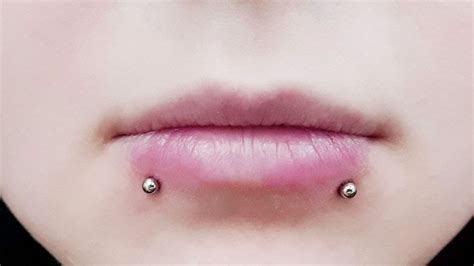 The Art of Lip Piercing: Discover the Beauty of Skin Growing Over Your Luxury Jewelry!