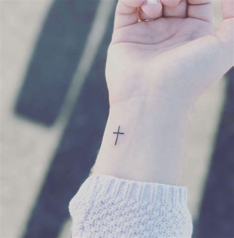 Small cross tattoo on Ryan's wrist.