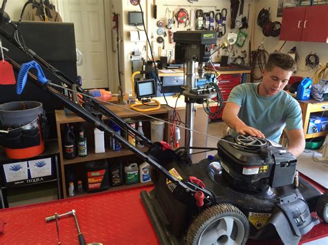 Small Engine Repair Technician Inspecting a Lawnmower