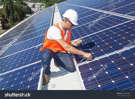 Solar Panel Repair Technician Checking Panels