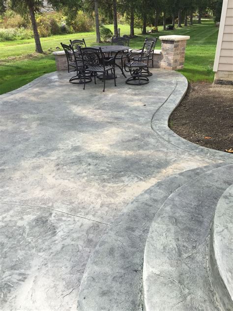 Rochester ny stamped concrete patio with a stained border. To view more