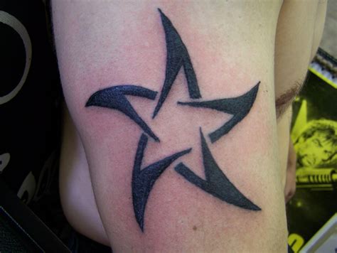Tattoo of Tribal star + M, In the center tattoo custom