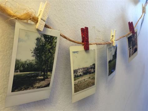 Image of a bedroom with a string of polaroids hanging across the wall
