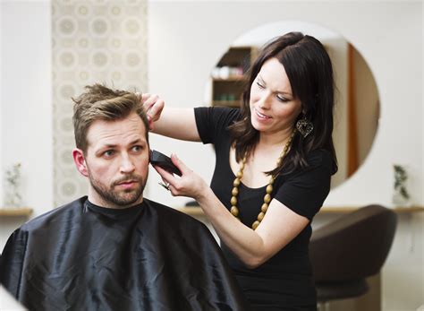 A barber styling a customer's hair.