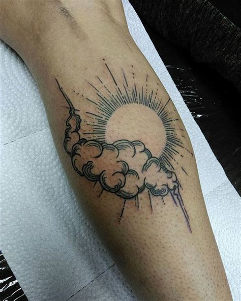Sun and clouds tattoo by Kirk Budden