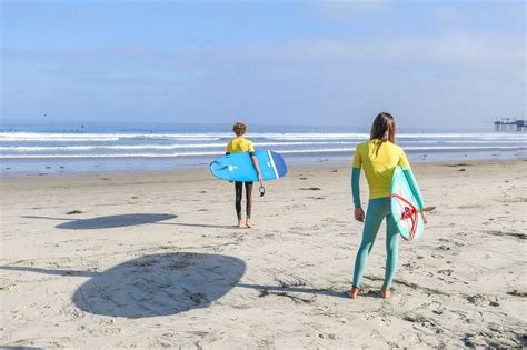 Surf instructor helping beginner