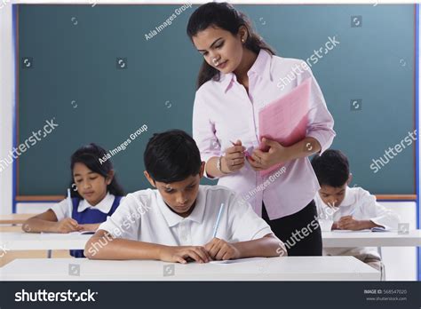 Teacher Hovering Over Student Guide For 2026