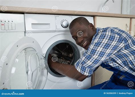 Technician Fixing a Washing Machine
