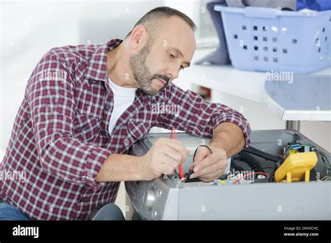 Technician Inspecting a Dryer