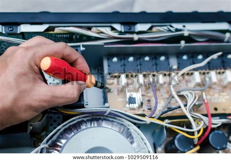 Technician Repairing Amplifier