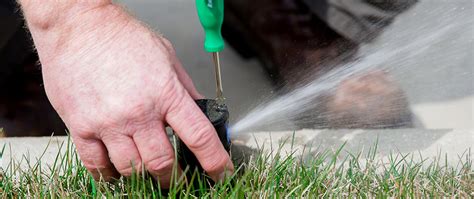 Technician Repairing Sprinkler System