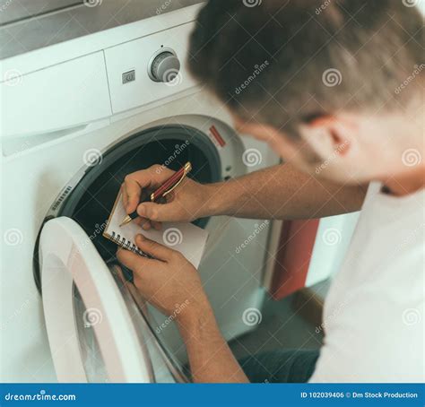 Technician Repairing a Washing Machine