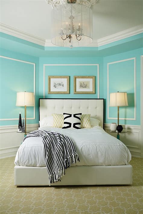Image of a Tiffany blue bedroom with a gallery wall featuring prints and paintings in calming colors.