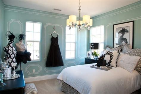 Image of a Tiffany blue bedroom with layered textures and patterns, including patterned bedding, cozy throws, and textured pillows.