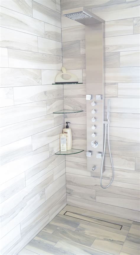 White subway tile shower with glass inserts after bathroom makeover. White subway tile shower