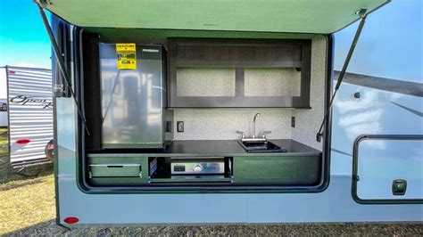 Rev Up Your Adventure with Our Deluxe Toy Hauler Featuring a Stylish Outdoor Kitchen!
