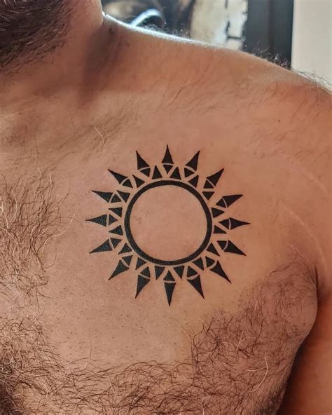 Black tribal sun tattoo on shoulder TattooMagz