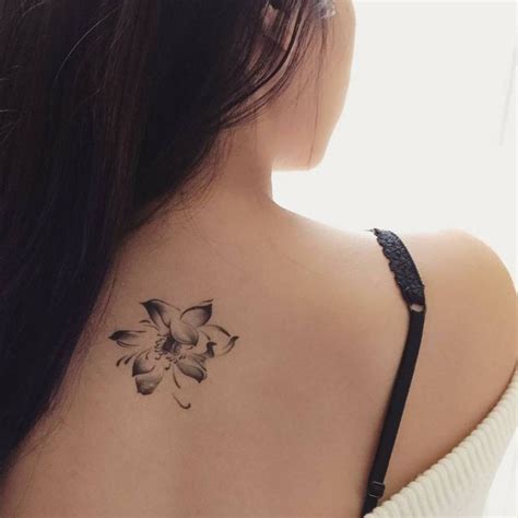 Upper back tattoo of a rose.
