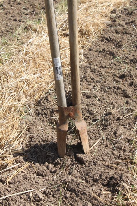 Using a Post Hole Digger to Put Stakes in the Ground