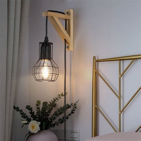 Wall lamp with cord plugged into an outlet