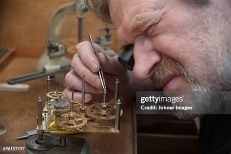 Watchmaker at work with tools
