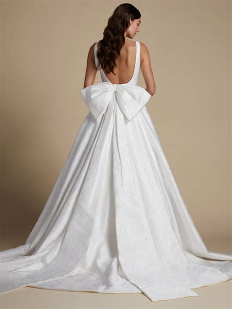 Breathtaking Elegance: The Enchanting Wedding Dress with a Stunning Bow on its Back