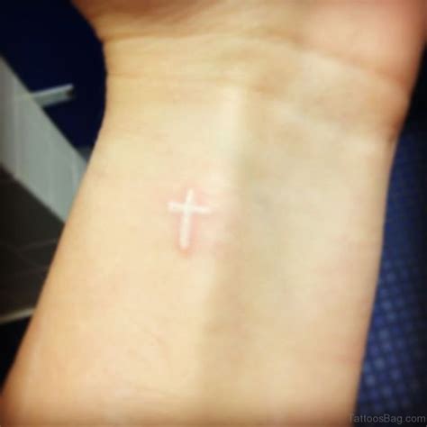 Small cross tattoo white ink on inside of wrist! Brandi