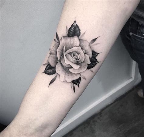 White rose tattoo above the knee
