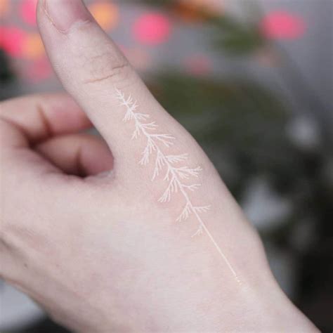 Finger emblems with a white ink twist: Add finesse to your skin canvas with white ink tattoos on fingers