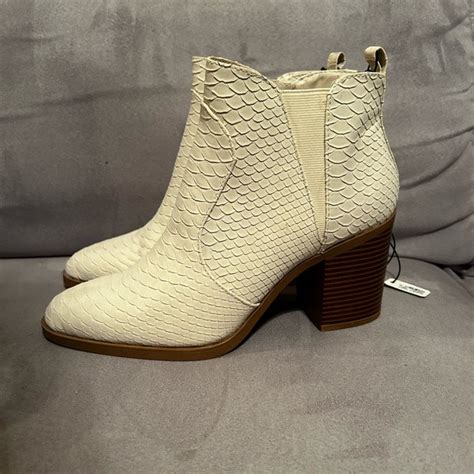 Step up your shoe game with our tantalizingly chic White Snake Skin Booties
