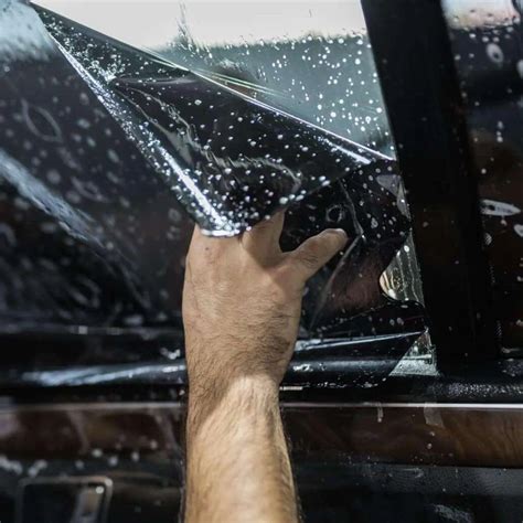 Image of a car with tinted windows, parked in a parking lot