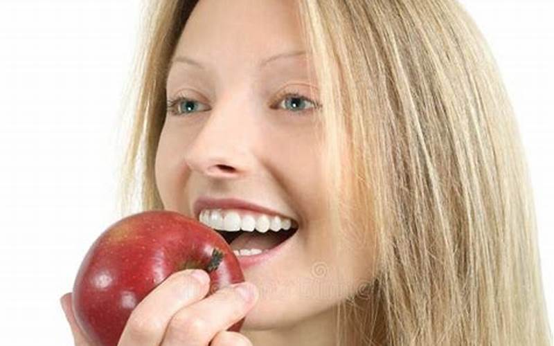 Woman Biting Into An Apple