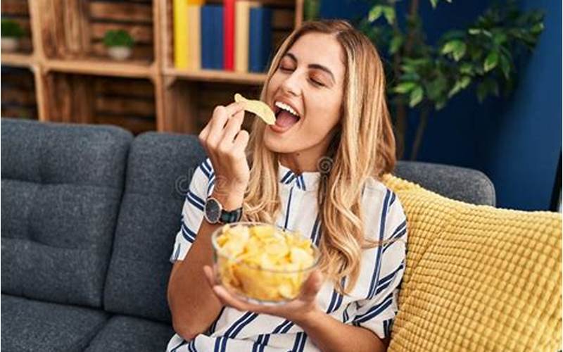 Woman Eating Chips And Dip