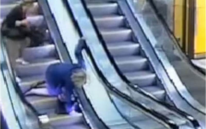 Woman Falling Down Escalator