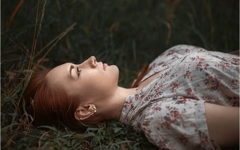 Woman Lying Down With A Sad Expression On Her Face