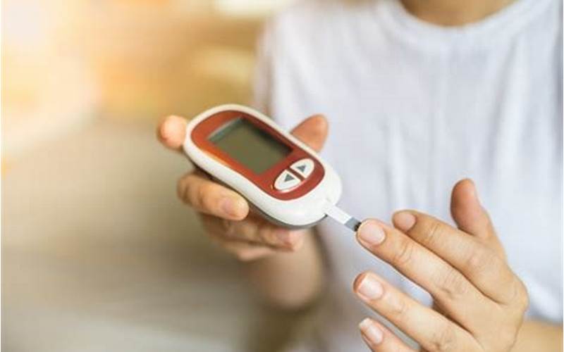 Woman Using Blood Glucose Meter