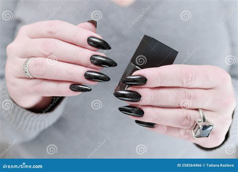Woman Black Manicure On Color