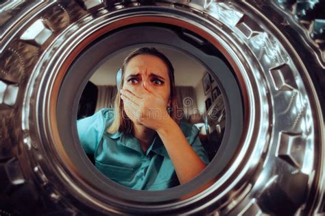 Woman Looking At Broken Washing Machine