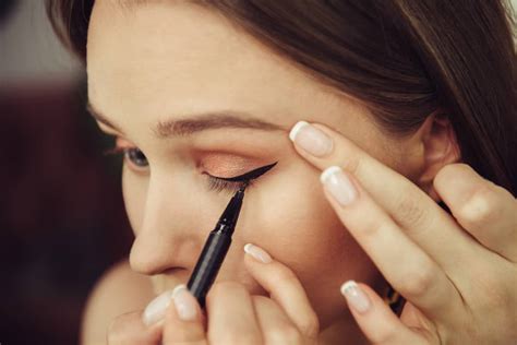 Woman applying eyeliner