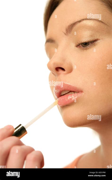 Woman applying lip gloss