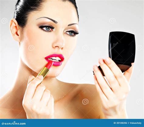 Woman applying lipstick