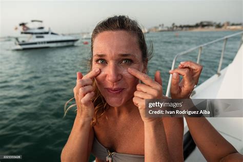 Woman applying sunscreen on boat