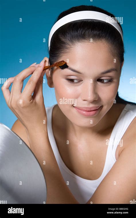 Woman grooming her eyebrows