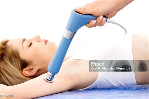 Woman receiving shockwave therapy Indianapolis