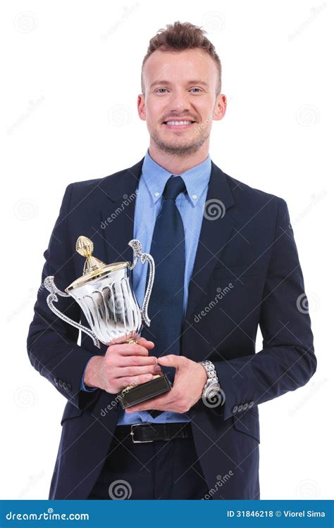 a%20person%20smiling%20and%20holding%20a%20trophy