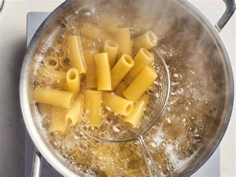 adding pasta to boiling water image