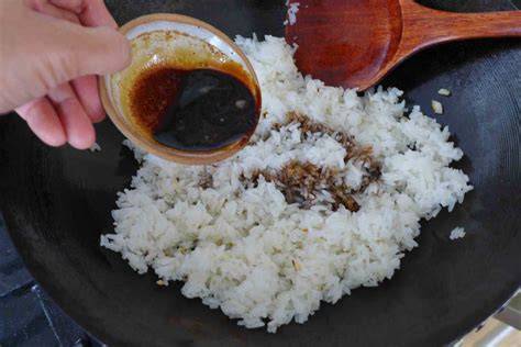 adding sauce to rice
