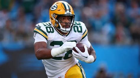 A photo of A.J. Dillon running the ball in a playoff game