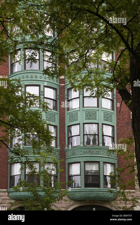 Several windows in a row and bay window on facade of urban apartment