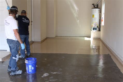 applying epoxy paint to garage floor